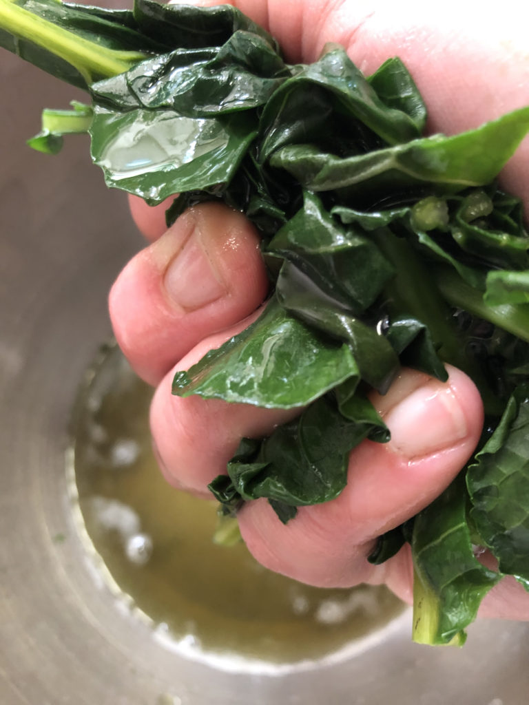 squeezing handfuls of greens