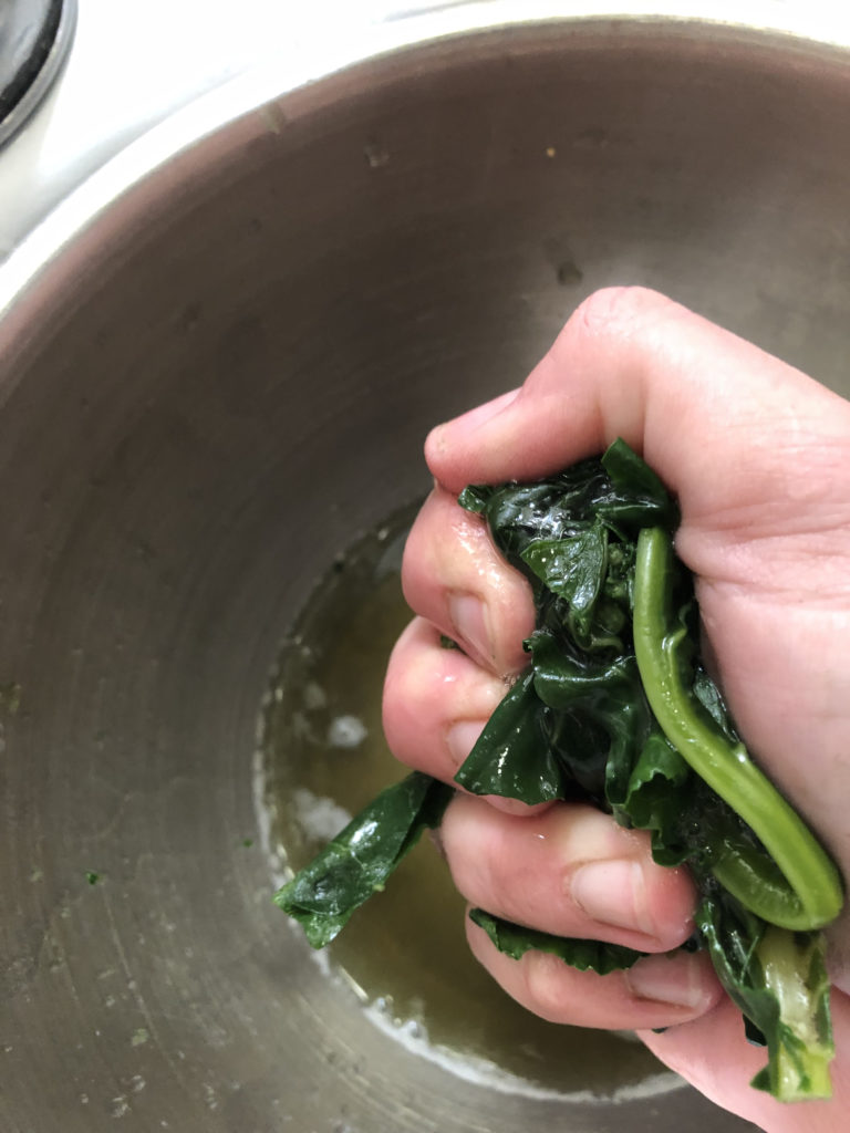 squeezing handfuls of greens