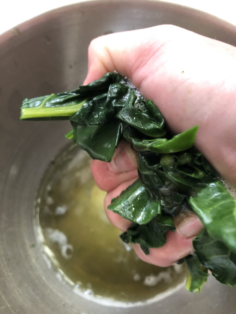 squeezing handfuls of greens